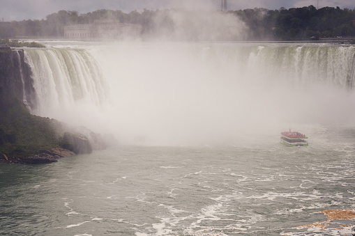 Niagara Falls, Canada; 10th of October, 2023. A ship cruise about to disappear into the waterfall mist in Niagara Falls