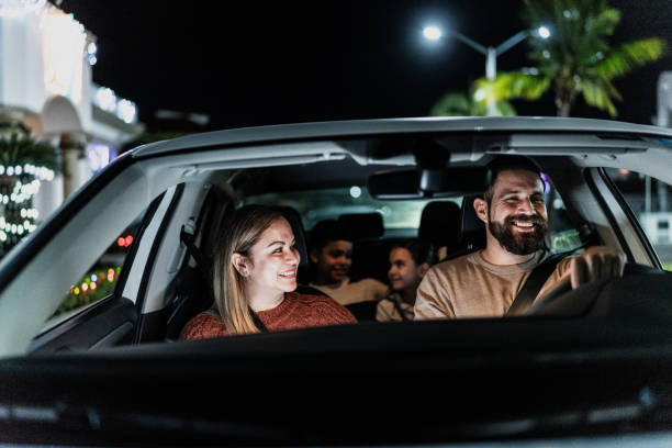 Family talking while traveling on car Family talking while traveling on car couple driving at night stock pictures, royalty-free photos & images