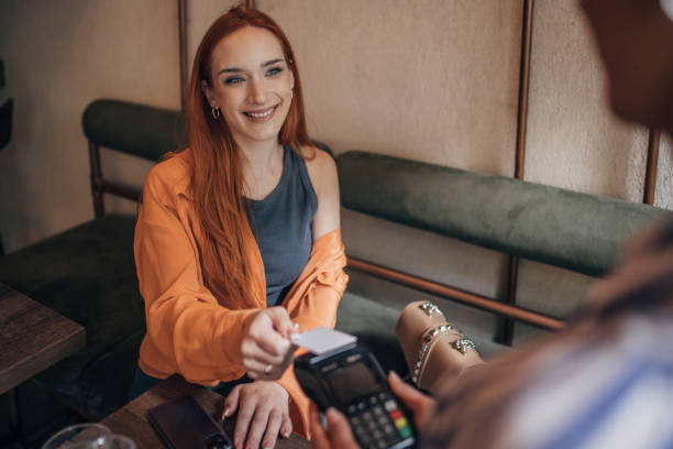 istock Woman making card payment 1854652875