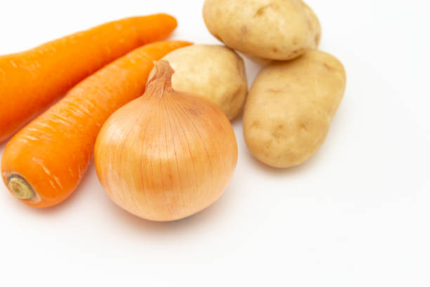 istock Carrots, onions and potatoes on a white background. 1854655979