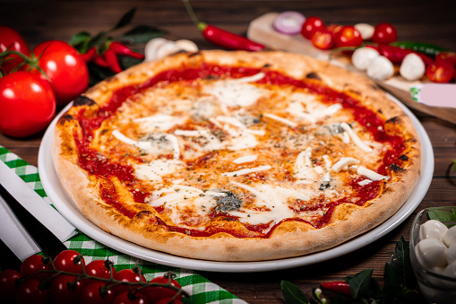 Pizza Quattro formaggi on wooden table