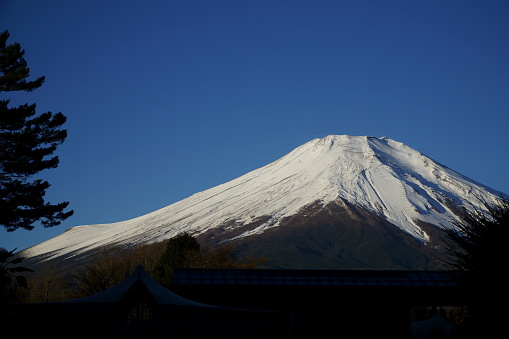 Snow-capped Mt. Fuji and winding mountain trail