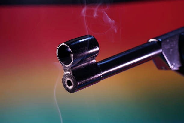 Close-up of the two metal tubes on the rifles top. A young Caucasian female hunter is holding the rifle with both hands.