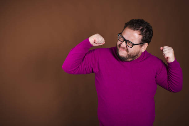 istock Funny fat man posing in studio on brown background. Different emotions. 1854700835