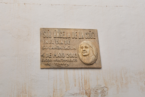 Ronda, Malaga, Spain- October 21, 2023: Commemorative plaque carved in stone to Sor Angela de la Cruz in Malaga town