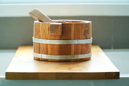 Wooden sauna bucket with a wooden spoon on a wooden stand,Interior Finnish sauna