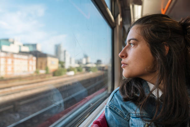istock Woman in train looking away from the window. 1854735858