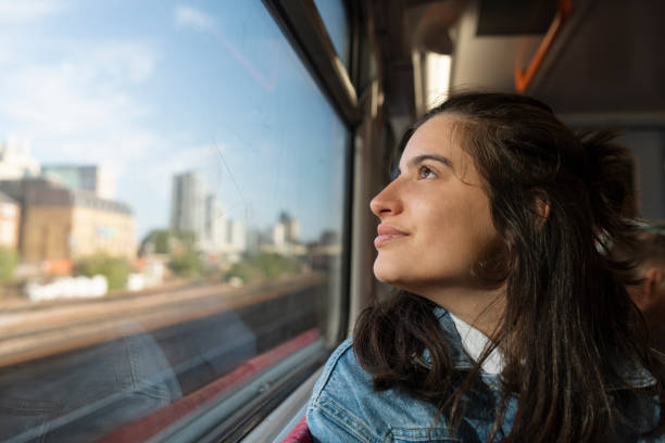 istock Woman in train looking away from the window. 1854735859