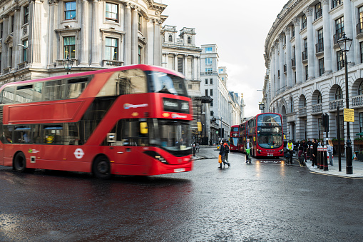 England, London, double decker bus blurring through city streets.