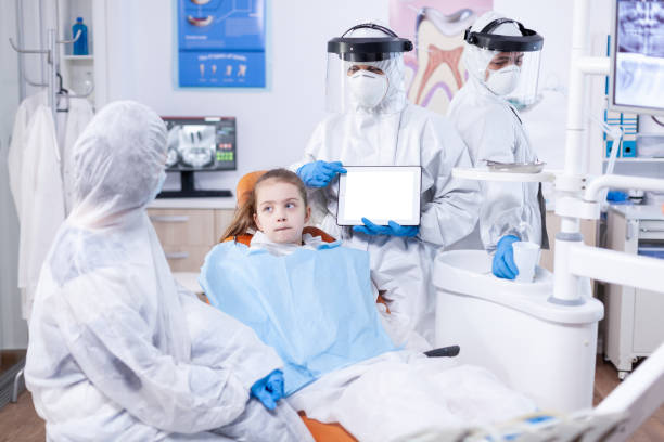 istock Pediatric dentist talking about dentistiry procedure 1854745612