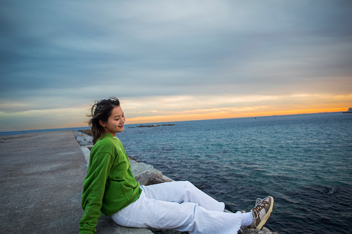 Young Chinese woman at the port of Barcelona