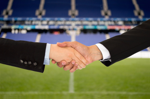 handshake in a business in the sport of soccer