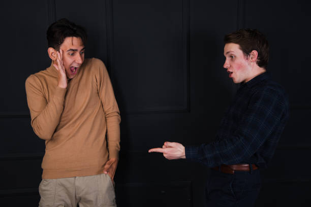 istock A beautiful couple is sorting things out. Two guys rejoice and quarrel. 1854756598