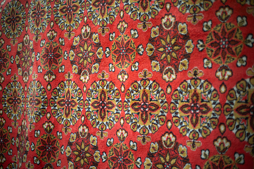 Carpet texture. Red carpet. Old fabric. The pattern on the fabric.