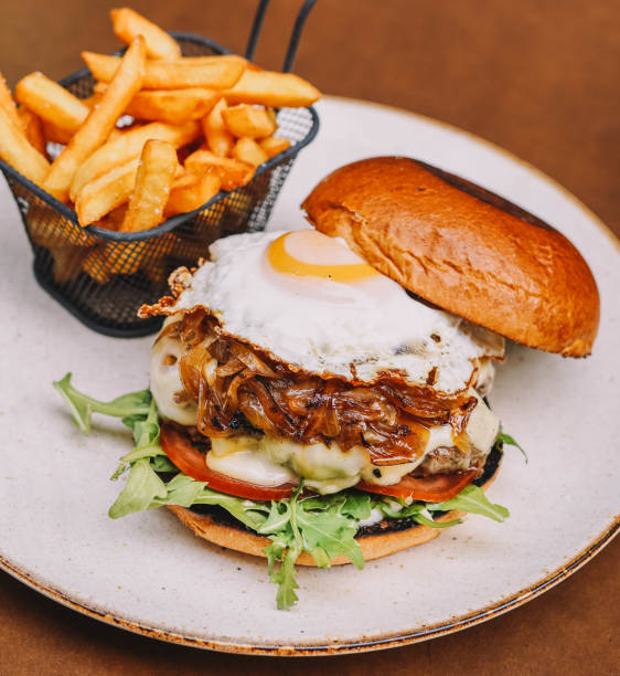 istock Full rustic beef burger with fries and fried egg 1854767428