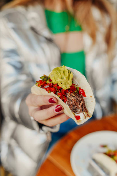 istock Mexican taco made with shredded pork and guacamole 1854773015