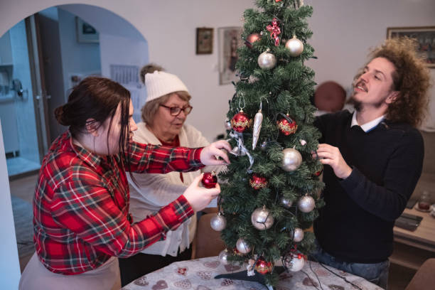 istock Multi-generational family decorating Christmas tree together 1854774393