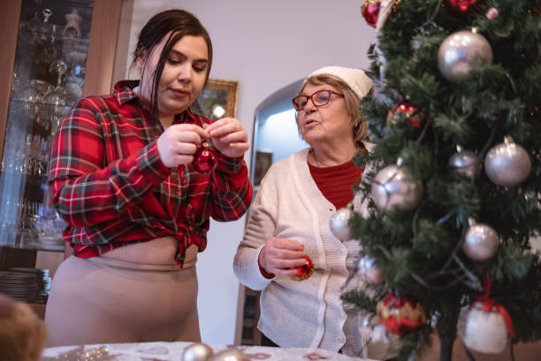 istock Multi-generational family decorating Christmas tree together 1854774974