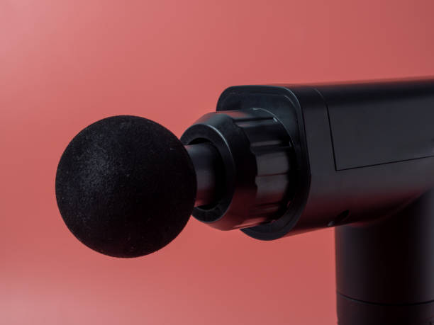 istock Massage gun on a pink background. 1854781638