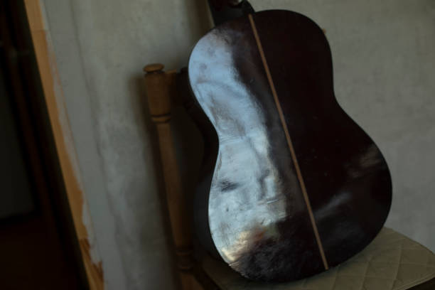 istock Classical guitar on a chair. Musical instrument in the apartment. Guitar deck. 1854792606