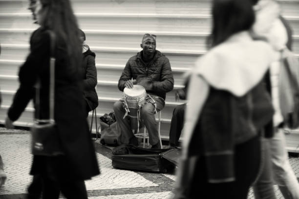 Lisbon, Portugal - January 15, 2023: A street musician plays percussion at the Rua Augusta street in Lisbon downtown.