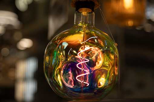 Colored lamp. Spiral in glass. Glass incandescent lamp. Interior detail.