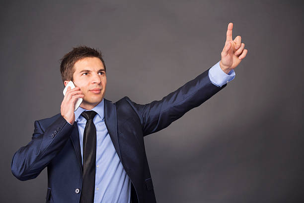 istock young businessman with mobile phone 185479542