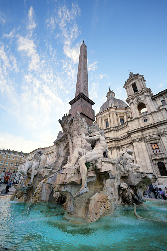 Rome Italy - November 15, 2023: Bernini's Fountain of the four Rivers with Egyptian obelisk and Church of Sant'Agnese in the middle of Piazza Navona.