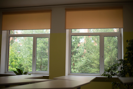 Windows in auditorium. Two large windows in room. Natural light in classroom. Details of interior of school.