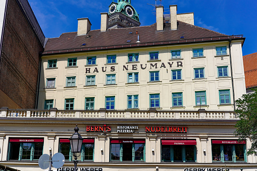 Facade of hotel named Haus Neumayr at the old town at City of München on a sunny summer day. Photo taken August 6th, 2019, Munich, Germany.