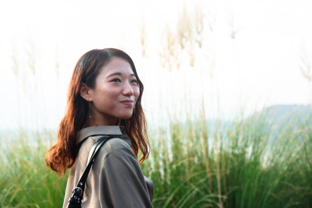 istock Beautiful young woman relaxing at lake side 1854835808