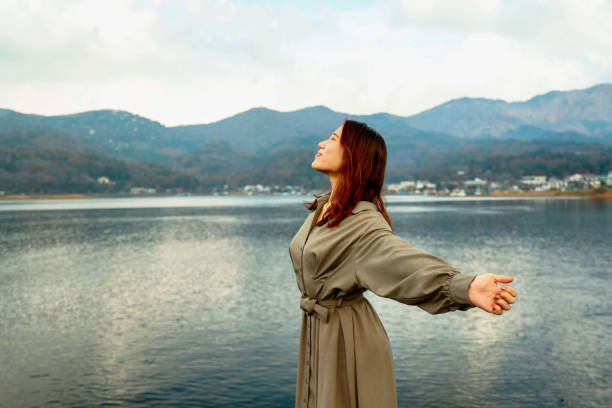istock Beautiful young woman relaxing at lake side 1854836577