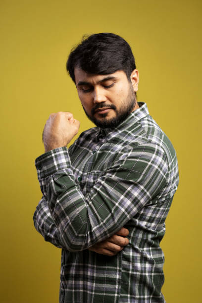 istock serious man looking down with clenched fist 1854851495
