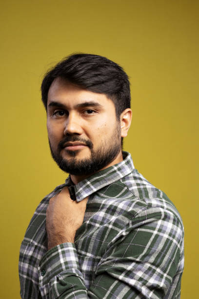 istock man fixing the collar of his button-down shirt 1854852034