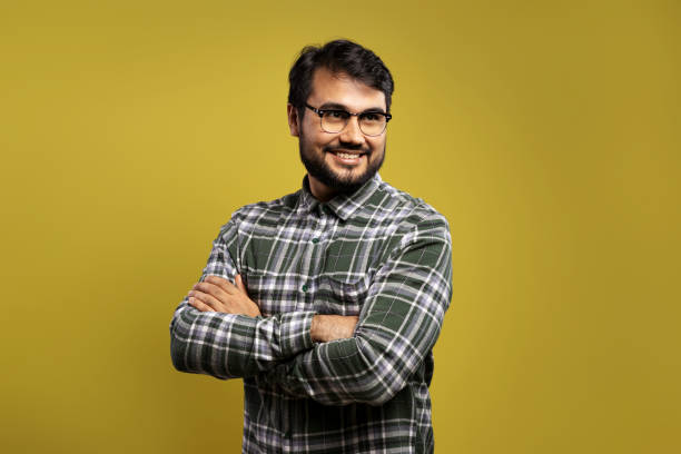 istock man in glasses with arms crossed, smiling and looking up 1854852049