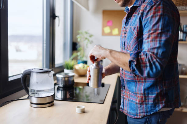 istock Man boiling his water in the kettle 1854855359