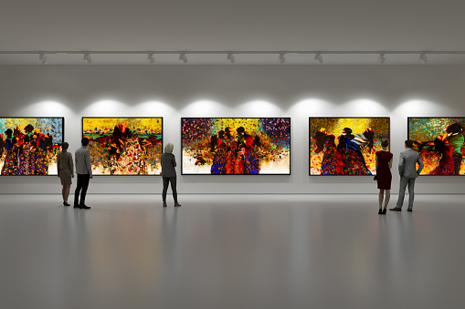 In an art center, visitors looks at the artist's collection. Modern colorful paintings on exhibition.