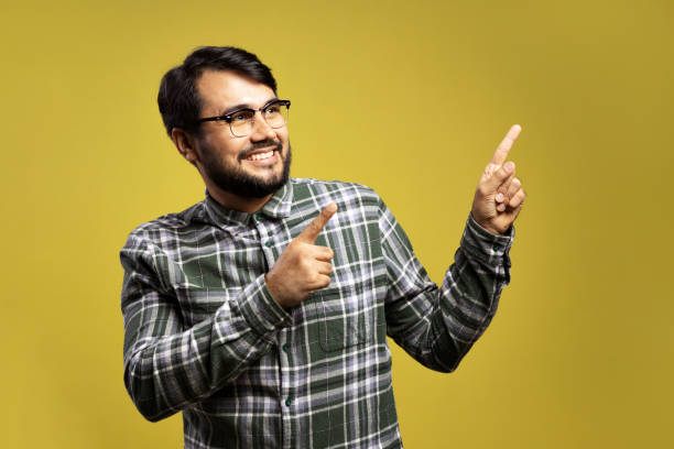istock man looking to the side and pointing with both hands 1854862324