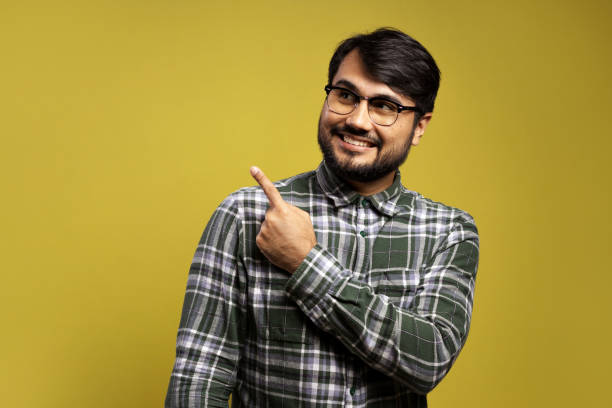istock man looking to the side and pointing with his left hand 1854862904