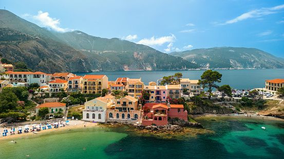 A beautiful small town of Assos on Kefalonia island, on a peaceful summer day. A lovely bay with sailboats, and a bunch of small, traditional, colorful mediterranean houses