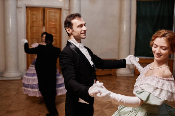istock Smiling Gentleman Wearing Tailcoat Dancing with Lady 1854866673