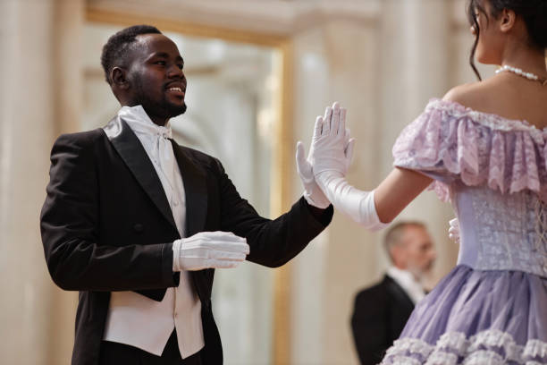 istock Black Gentleman Dancing with Lady in Palace Ballroom 1854870424