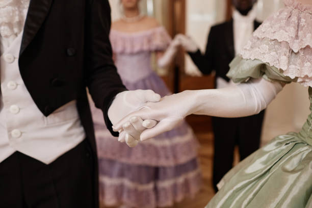 Lady and Gentleman Holding Hands Wearing Gloves