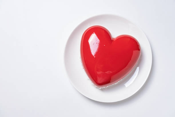 istock heart shaped glazed valentine cake on white plate on white background 1854870450