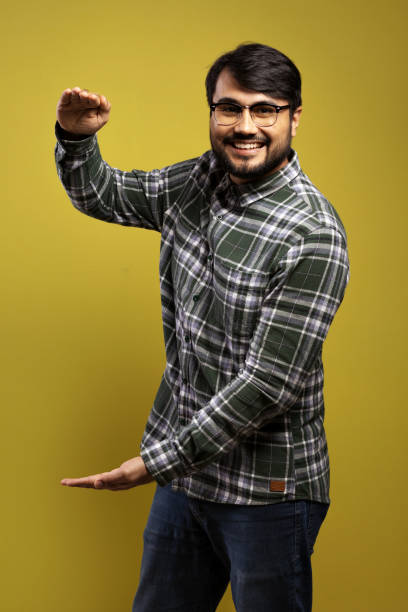 istock man smiling, with hands open as if measuring something 1854872546