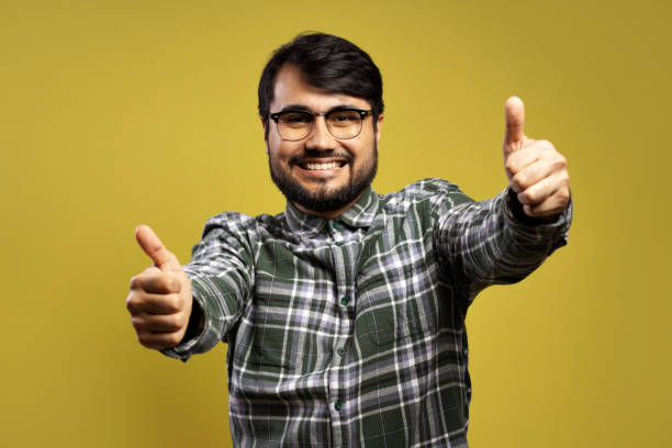 istock man smiling and giving thumbs up with both hands 1854872554
