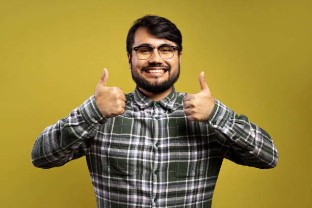 istock man smiling and giving thumbs up with both hands 1854872564