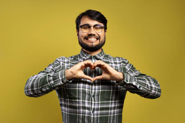 istock man smiling making heart with his hands 1854873094