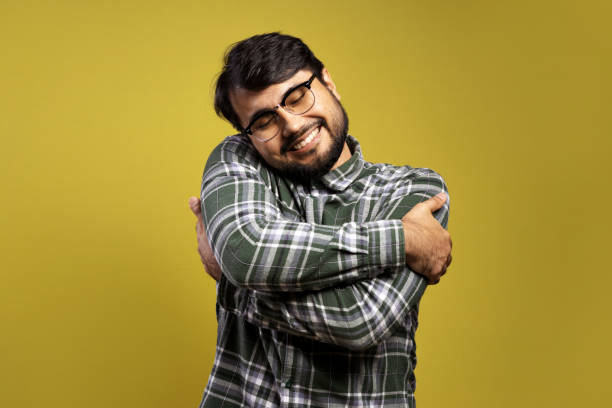 istock man smiling and giving himself a big hug 1854873609