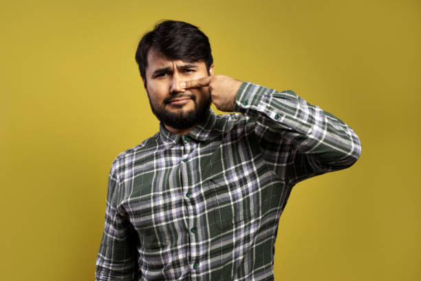 istock man with runny nose and pointing at it 1854875174